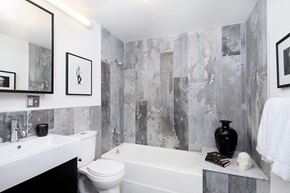 Brooklyn apartment for rent - a bathroom with a toilet and a tub and a sink