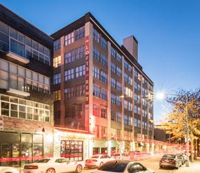 Brooklyn apartment for rent - a city street with cars parked in front of a building