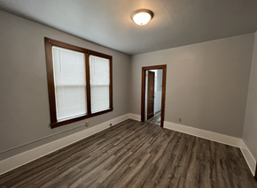 Fremont apartment for rent - an empty living room with wood floors and a door to a hallway