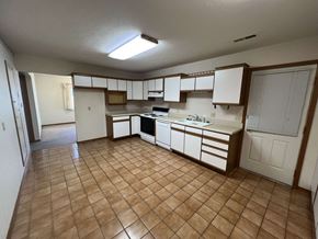 Fremont apartment for rent - A kitchen with brown tiles and white cabinets.