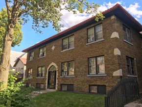 Milwaukee apartment for rent - a brick house with a yard and a tree