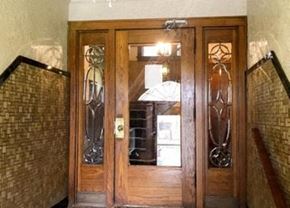 Milwaukee apartment for rent - a wooden door with glass windows in a building