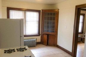 Milwaukee apartment for rent - an empty kitchen with a stove and a refrigerator