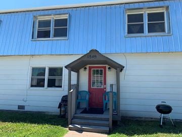 Fremont apartment for rent - A blue house with a red door and a small porch.