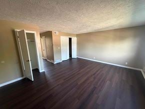 Fremont apartment for rent - A room with wooden floors and white walls.