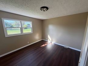 Fremont apartment for rent - A room with a window and wooden floors.