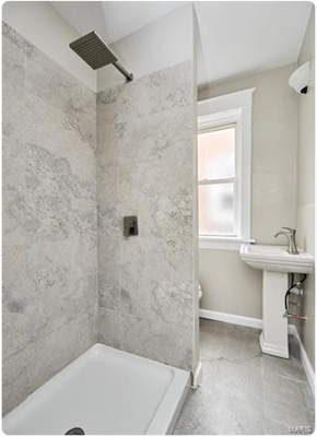 St. Louis apartment for rent - a bathroom with a tub and a sink and a window