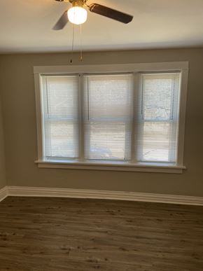 St. Louis apartment for rent - a bedroom with a large window and a ceiling fan