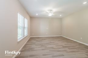 Jacksonville house for rent - the spacious living room with tile flooring and a ceiling fan