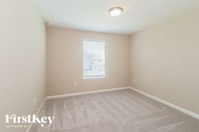 Jacksonville house for rent - a bedroom with a carpeted floor and a window