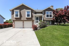 Belton house for rent - a tan house with a white garage door and a lawn