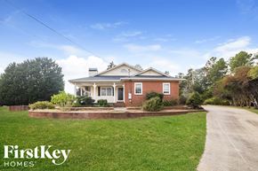 Dallas house for rent - a brick house with a sidewalk in front of it
