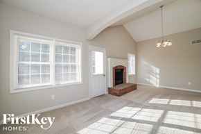 Dallas house for rent - an empty living room with a fireplace and a window