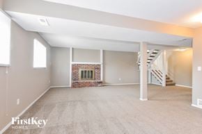 Lake Saint Louis house for rent - A spacious living room with a fireplace and a staircase.