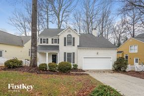 Greensboro house for rent - A house with a white garage door is featured in the image.