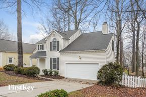 Greensboro house for rent - A house with a white garage door is for sale by FirstKey Homes.