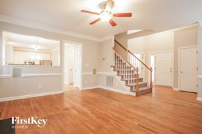 Greensboro house for rent - A spacious living room with a staircase leading to the upper floor.