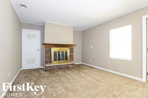 Florissant house for rent - A room with a fireplace and a window.