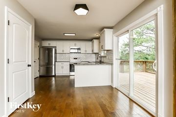O'fallon house for rent - A kitchen with a white countertop and wooden floors.