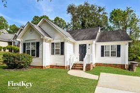 Browns Summit house for rent - a white house with black shutters and a green lawn