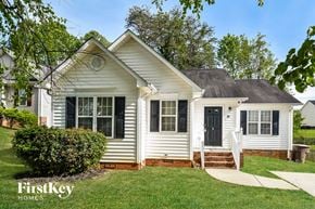 Browns Summit house for rent - a white house with black shutters and a front yard