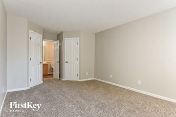 Browns Summit house for rent - a spacious living room with carpet and a door to the bathroom