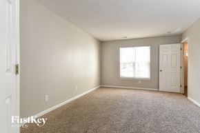 Browns Summit house for rent - a bedroom with carpet and a white door and window