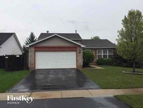 Lake In The Hills house for rent - A house with a garage door is shown in the image.