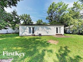 Saint Peters house for rent - a small white house on the grass near the water