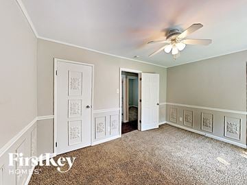 Saint Peters house for rent - a bedroom with a ceiling fan and a door to a closet