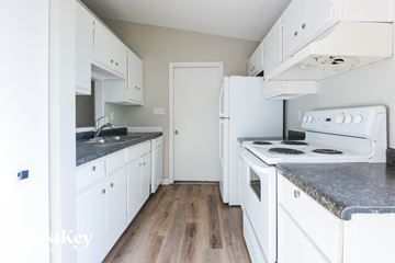 Whiteland house for rent - A kitchen with white appliances and cabinets.