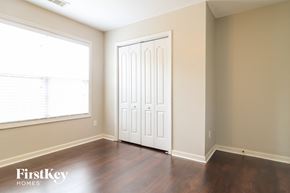 Dallas house for rent - a living room with wood floors and a white door and a window