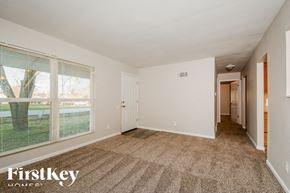 O'fallon house for rent - A room with a carpeted floor and a sliding glass door.