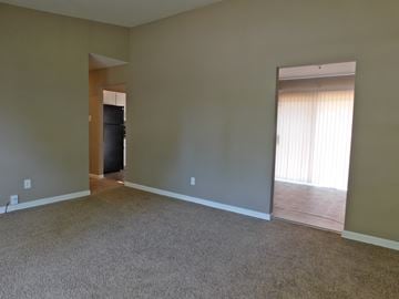 Florissant house for rent - a living room with a carpet and a door to a kitchen