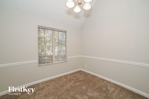 Newnan house for rent - a bedroom with a carpeted floor and a window