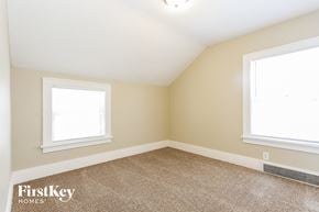 Waukegan house for rent - the bedroom of a home with two windows and a carpeted floor