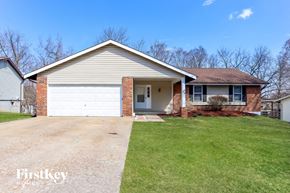 Saint Peters house for rent - A house with a garage and a driveway in front.