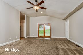 Saint Peters house for rent - an empty living room with a ceiling fan and a door to the backyard