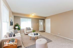 Indianapolis house for rent - A living room with a sofa, armchair, and coffee table.