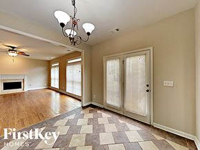 Dallas house for rent - an empty living room with a fireplace and a checkered floor