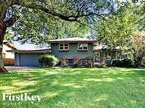 West Chicago house for rent - a blue house with a yard and a tree
