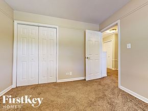 West Chicago house for rent - a bedroom with two closets and a door to a hallway