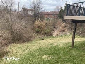 Covington house for rent - A backyard with a deck and a grassy area.