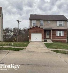 Covington house for rent - A brick house with a garage door is for sale.