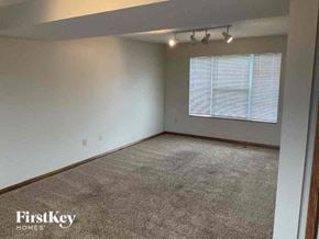 Covington house for rent - A room with a carpeted floor and a window with blinds.