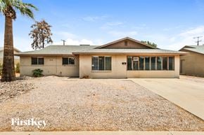 Tempe house for rent - A house with a palm tree in front of it.