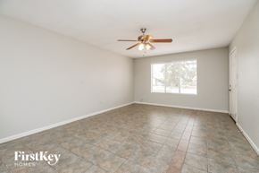 Tempe house for rent - A room with a ceiling fan and tiled floor.