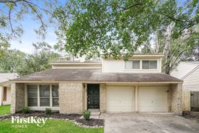 Spring house for rent - a white brick house with a large tree in front of it