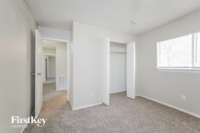 Spring house for rent - a bedroom with white walls and carpet and a door to a closet