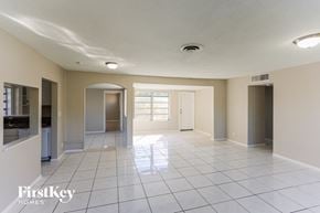 Plantation house for rent - an empty kitchen and living room with a tile floor